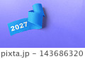 Blue torn paper with the year 2027 written on it, isolated on a purple background. Concept of Happy New Year 143686320