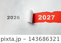 White paper torn revealing the year 2027 instead of 2026 on a red background. Concept of changing years, transition, future, and time passing. Concept of Happy New Year 143686321