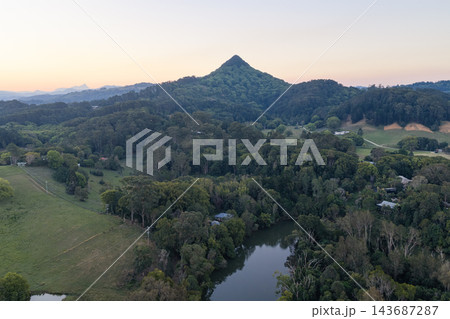Aerial view along the Brunswick River and forested hinterland toward Mount Chincogan at sunset near Mullumbimby, New South Wales, Australia. 143687287
