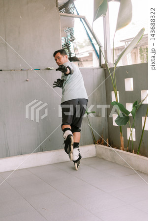 Active person inline skating in outdoor space with protective gear Active person inline skating in outdoor space with protective gear 143688322