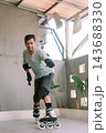 Active man inline skating with protective gear outdoors 143688330