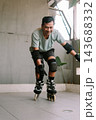 Active man practicing inline skating wearing protective gear 143688332