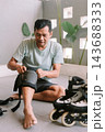 Person preparing protective knee pads before inline skating session 143688333