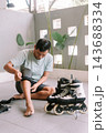 Person preparing for inline skating by putting on knee pads 143688334