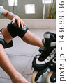 Person Adjusting Protective Knee Pad Before Inline Skating Outdoors 143688336