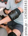 Person preparing with protective gear for inline skating activity 143688343