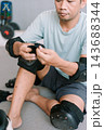 Man Preparing Protective Gear for Inline Skating 143688344