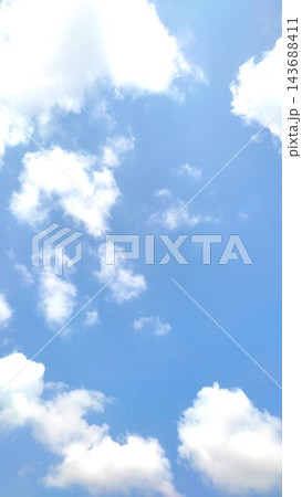 Clear Blue Sky with White Fluffy Cumulus Clouds Background Clear Blue Sky with White Fluffy Cumulus Clouds Background 143688411