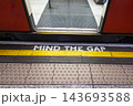 Mind the gap warning painted on an underground station platform 143693588