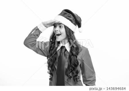 Funny child girl on christmas new year isolated in white. Teenager in santa hat. 143694684