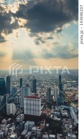 Bangkok city skyline at sunset with modern buildings, downtown urban panorama of Thailand capital with skyscrapers and evening sky, aerial drone view 143696207