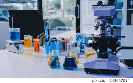 Medical or scientific researcher or man doctor looking at a test tube of clear solution in a laboratory Medical or scientific researcher or man doctor looking at a test tube of clear solution in a laboratory 143697014
