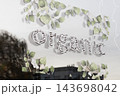 Organic decal sign with green leaf border on a clear shop window 143698042