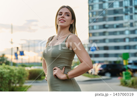 Confident young woman standing hands on hips city portrait Confident young woman standing hands on hips city portrait 143700319