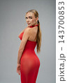 Rear view of woman in sheer red dress looking over shoulder 143700853