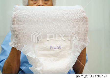 Asian senior woman patient wearing adult incontinence diaper pad in hospital. Asian senior woman patient wearing adult incontinence diaper pad in hospital. 143701474