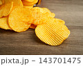 Potato chips in open bag, delicious BBQ seasoning spicy for crips, thin slice deep fried snack fast food. 143701475