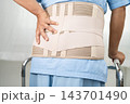 Asian senior pain back wearing elastic support belt with walker. 143701490