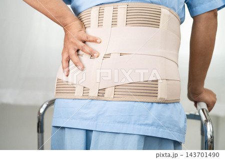 Asian senior pain back wearing elastic support belt with walker. Asian senior pain back wearing elastic support belt with walker. 143701490