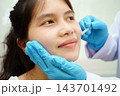 Asian woman receiving lip contouring procedure augmentation performed on face. 143701492