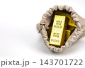 Close-up of an opened beige suede drawstring pouch revealing shiny 999.9 fine gold bullion bars weighing 200 grams each on a white background, concept of hidden value, unexpected treasure, savings 143701722