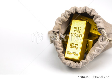 Close-up of an opened beige suede drawstring pouch revealing shiny 999.9 fine gold bullion bars weighing 200 grams each on a white background, concept of hidden value, unexpected treasure, savings 143701722