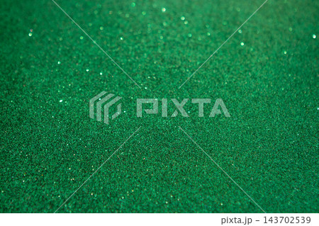 Green glitter texture background with sparkling bokeh and shimmering festive surface Green glitter texture background with sparkling bokeh and shimmering festive surface 143702539