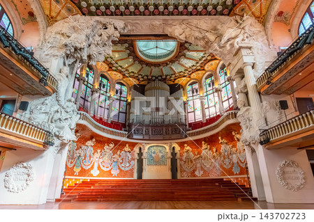 Ornate modernista concert hall with stained glass skylight, ceramic roses and chandeliers in Palau de la Musica Catalana, Barcelona Ornate modernista concert hall with stained glass skylight, ceramic roses and chandeliers in Palau de la Musica Catalana, Barcelona 143702723