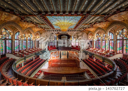 Elevated view of Palau de la Musica Catalana concert hall with stained glass ceiling and red seats in Barcelona Elevated view of Palau de la Musica Catalana concert hall with stained glass ceiling and red seats in Barcelona 143702727