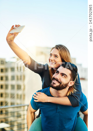 City, piggyback and selfie of couple with love, caring or bonding together on vacation in Spain. Dating people, boyfriend and girlfriend with photography for social media, memories and travel outdoor 143702965