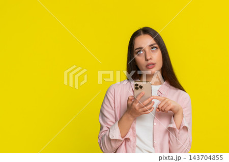 Woman scrolling social media smartphone rolling eyes irritated annoyed bored negative tired reaction Woman scrolling social media smartphone rolling eyes irritated annoyed bored negative tired reaction 143704855