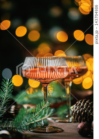 Elegant Rose Champagne Glasses with Christmas Lights and Holiday Decorations Elegant Rose Champagne Glasses with Christmas Lights and Holiday Decorations 143704986