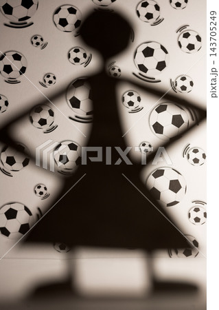 Soccer Fan Silhouette Against Football Pattern Background 143705249