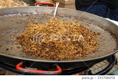 Traditional Spanish Paella with Squid and Rice Cooking in Giant Traditional Spanish Paella with Squid and Rice Cooking in Giant 143706058