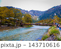 Tourists visit the Kappa Bridge a Kamikochi landmark featuring the Japanese Alps and the river which is a popular destination for nature sightseeing and hiking. 143710616