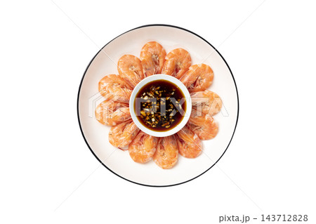 Boiled whole shrimp arranged in a circle on a white plate with garlic soy dipping sauce, top view isolated on white background 143712828