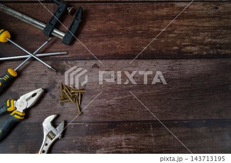 Hand tools and screws on wooden background with copy space Hand tools and screws on wooden background with copy space 143713195