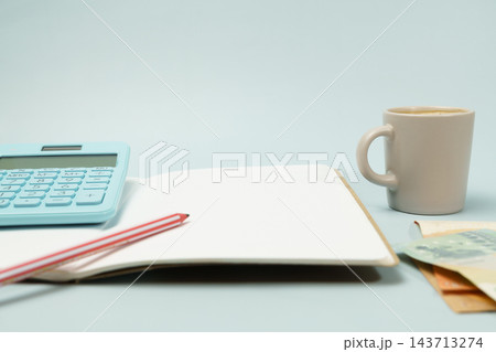 Personal financial planning calculating budget with coffee and money Personal financial planning calculating budget with coffee and money 143713274