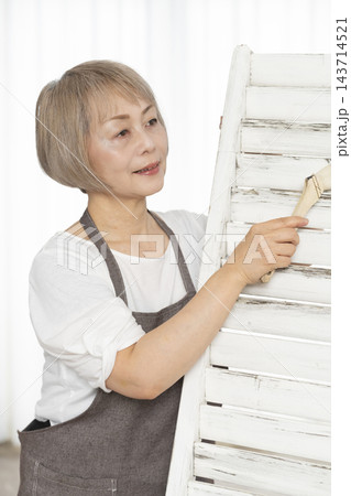リビングで趣味のDIYで椅子を作るシニア女性 143714521