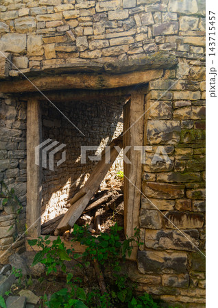 Stone wall ruins with wooden window frame Stone wall ruins with wooden window frame 143715457