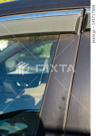 Bird Droppings on Car Window and Door Panel, Dirty Vehicle Glass With Stain and Mess 143717806