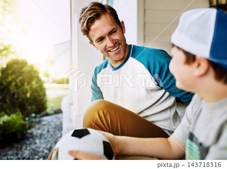 Happy, kid and dad with soccer ball by home for outdoor sports, bonding and conversation on weekend. Smile, man and son outside house with love for exercise, practice and break on fathers day 143718316