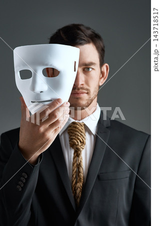 Portrait, business man and mask for secret spy in studio isolated on gray background. Fake face, suit and industrial espionage disguise of agent with rope noose for identity, confidential and fraud Portrait, business man and mask for secret spy in studio isolated on gray background. Fake face, suit and industrial espionage disguise of agent with rope noose for identity, confidential and fraud 143718517