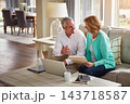 Senior couple, paperwork and finance on couch with laptop, smile or check for taxes in home. Old man, woman and computer with documents for compliance, audit or investment report for budget review 143718587