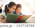 Children, reading and siblings in home with book for story time, education and literature adventure for storytelling. Boy, girl and together on floor for fantasy or bonding, learning and development. 143718588