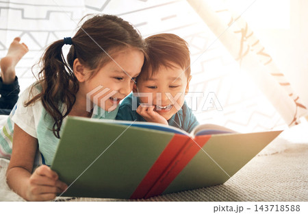 Children, reading and siblings in home with book for story time, education and literature adventure for storytelling. Boy, girl and together on floor for fantasy or bonding, learning and development. Children, reading and siblings in home with book for story time, education and literature adventure for storytelling. Boy, girl and together on floor for fantasy or bonding, learning and development. 143718588