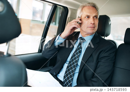 Talking, mature man and phone call in taxi for transport, schedule meeting, communication in backseat. Mobile, vehicle and employee with paperwork for conversation, commute or travel on business trip Talking, mature man and phone call in taxi for transport, schedule meeting, communication in backseat. Mobile, vehicle and employee with paperwork for conversation, commute or travel on business trip 143718593