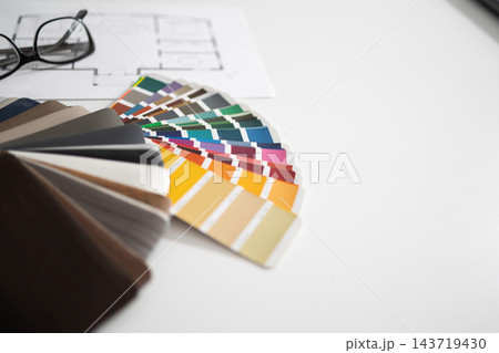 Color swatch fan with fabric swatches in a warm interior design palette 143719430