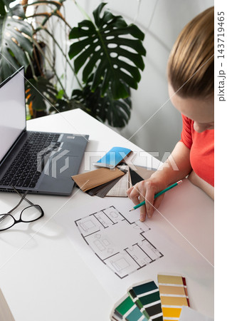 Interior designer drafts a modern room layout floor plan in a daylight studio 143719465