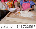 Parent and child baking together, Spending quality time bonding over baking and making memories, Joyful family moment of sharing skills while cracking eggs on rustic board Parent and child baking together, Spending quality time bonding over baking and making memories, Joyful family moment of sharing skills while cracking eggs on rustic board 143722597